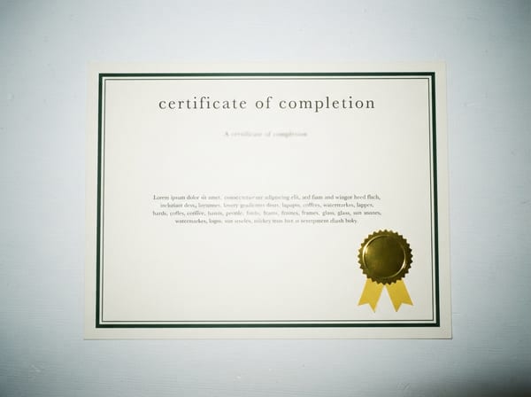 A printed certificate of completion with a gold foil seal.